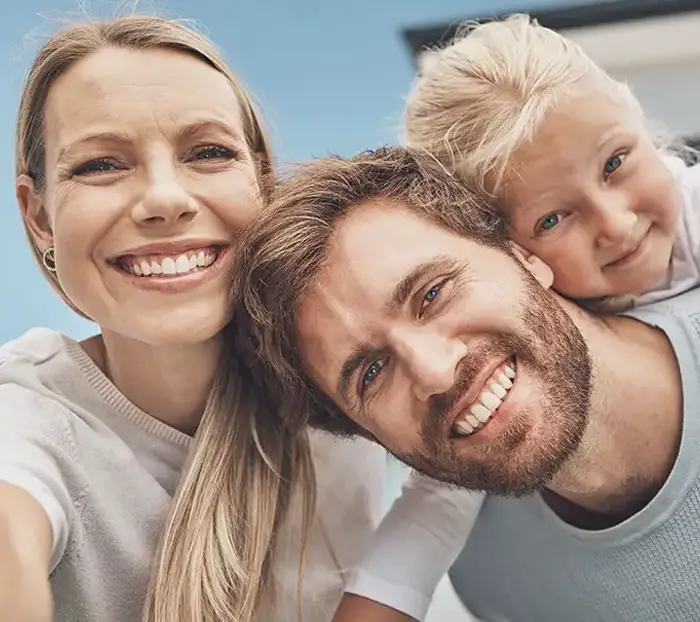 Young family taking a selfie after moving in
